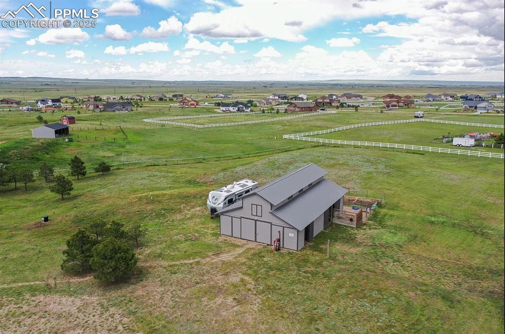 Image 36 of 44: Aerial view of sparsely populated area featuring a pastoral area
