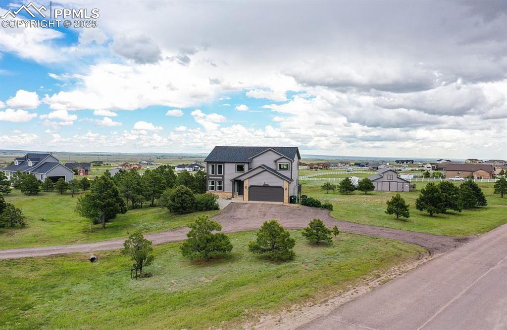 Image 43 of 44: View of front of home with driveway, a garage, and a front lawn