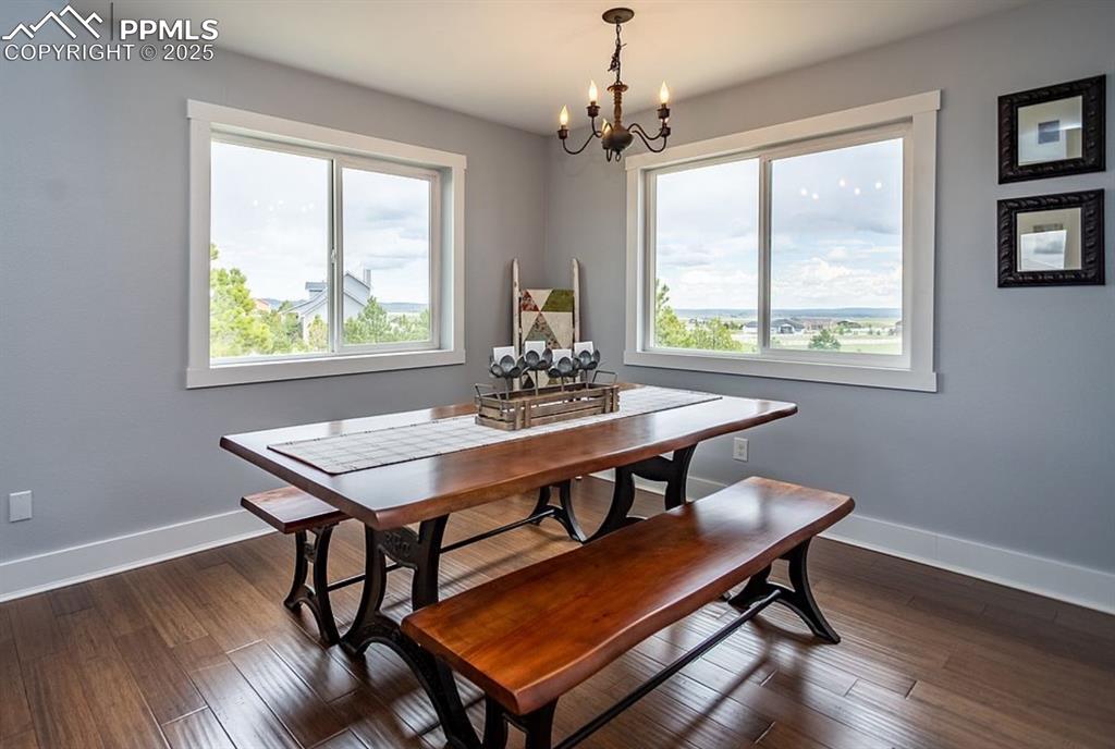 Image 7 of 44: Dining space featuring healthy amount of natural light, dark wood-style flo