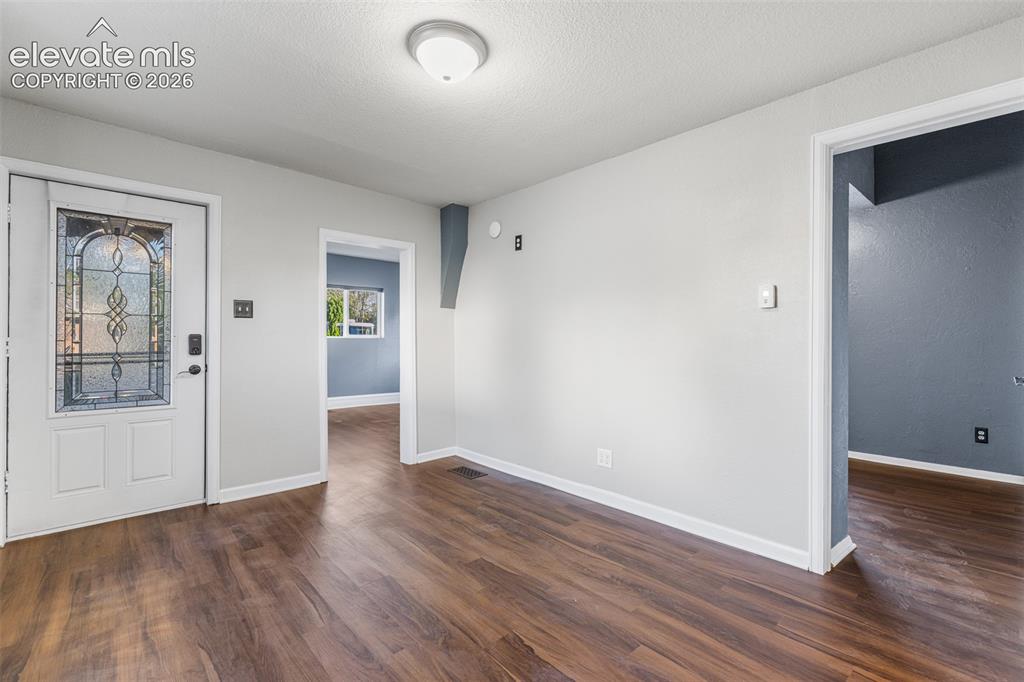 Image 7 of 32: Entryway featuring wood-finish flooring, a white exterior door with decorat