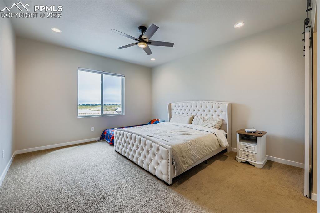 Image 11 of 28: Bedroom featuring carpet, a ceiling fan, and recessed lighting
