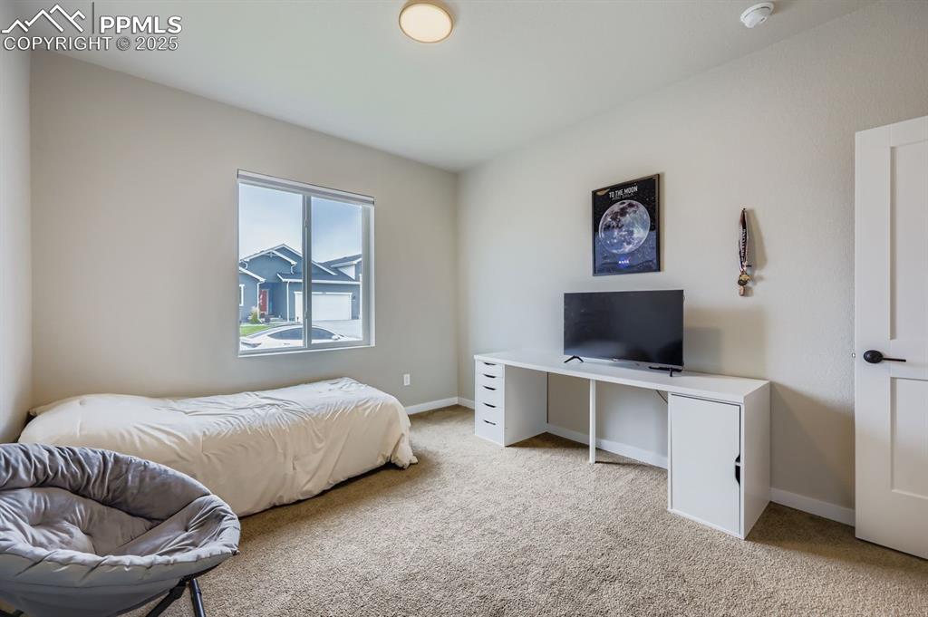 Image 15 of 28: Bedroom featuring light colored carpet and baseboards