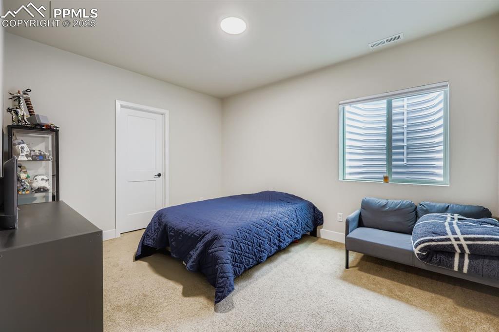 Image 20 of 28: Bedroom featuring light carpet and baseboards