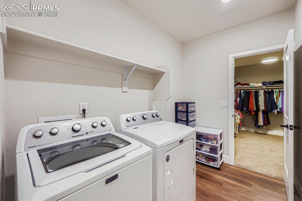 Image 24 of 28: Laundry area with light wood-type flooring and washer and dryer