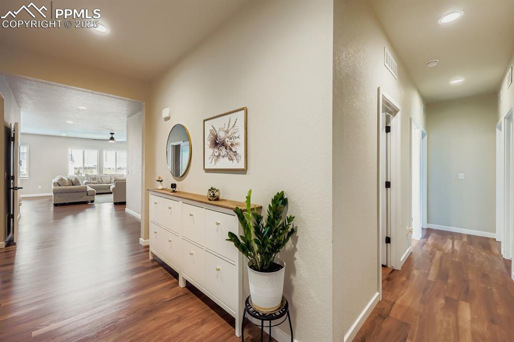 Image 4 of 28: Corridor featuring dark wood-type flooring and recessed lighting
