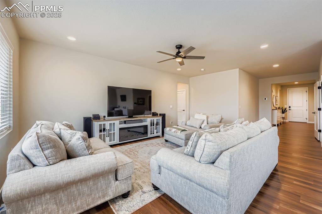 Image 6 of 28: Living room featuring wood finished floors, recessed lighting, and a ceilin