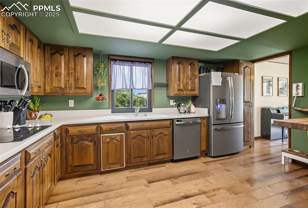 Image 13 of 26: Cozy kitchen featuring wood flooring and ample storage space