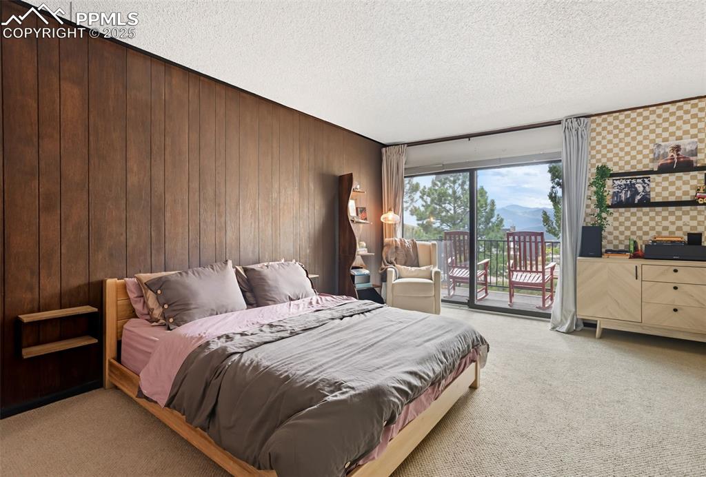 Image 17 of 26: Spacious primary bedroom oasis includes access to a private balcony