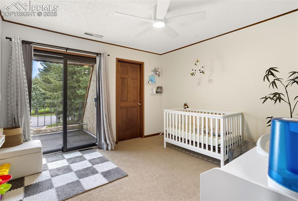 Image 21 of 26: Second bedroom features access to balcony shared with third bedroom