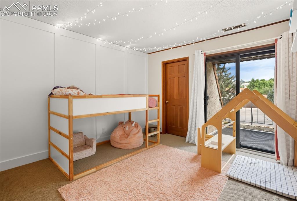 Image 23 of 26: Third bedroom features access to balcony shared with second bedroom