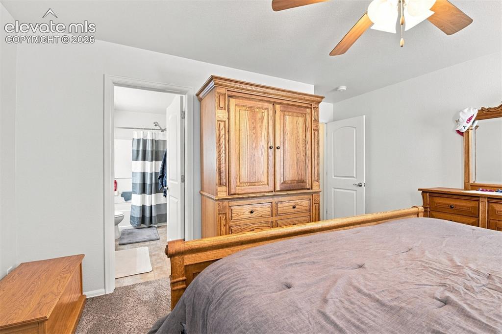 Image 14 of 32: Carpeted flooring, white walls, and a ceiling fan with integrated lighting
