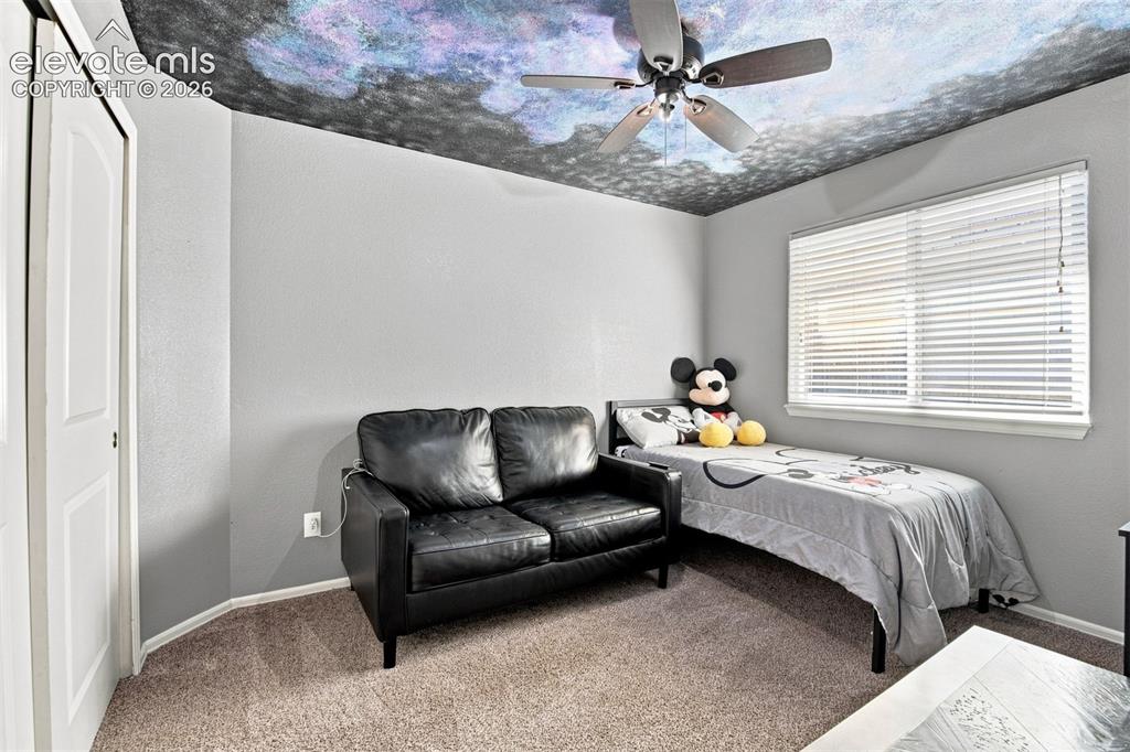 Image 20 of 32: Textured ceiling, ceiling fan, window with blinds, light gray wall paint, a