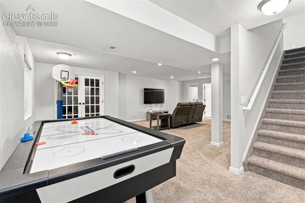 Image 22 of 32: Finished lower level featuring recessed lighting, plush carpet flooring, an
