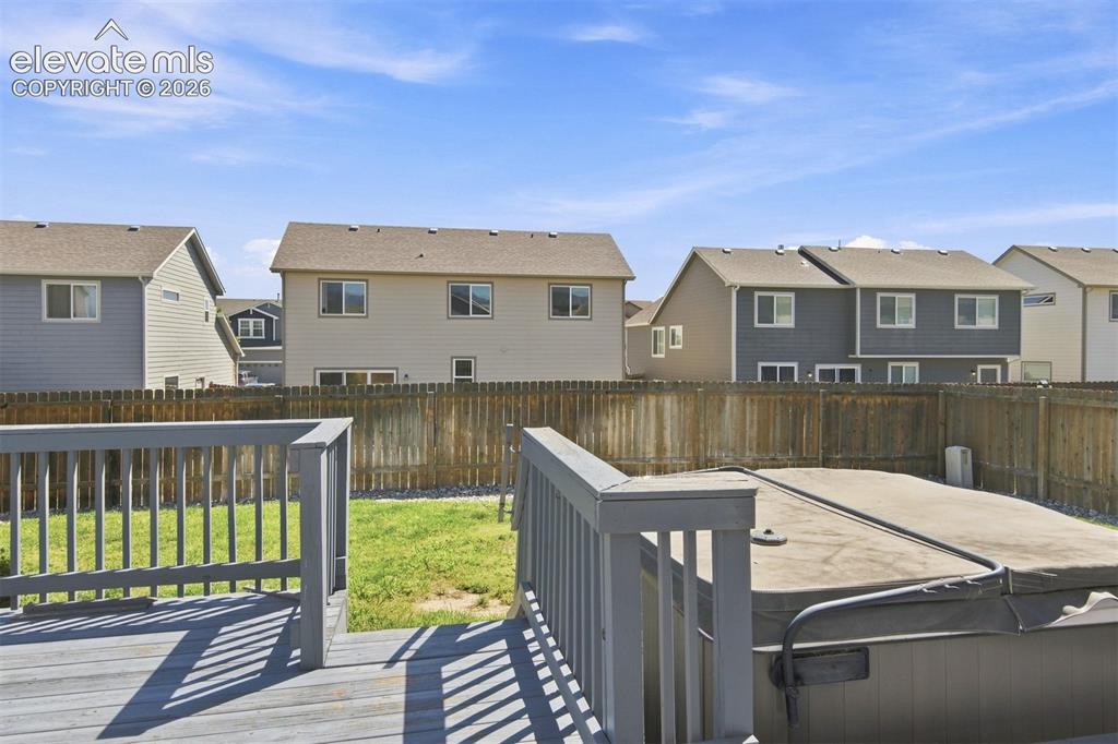Image 29 of 32: Wood deck with railing and a covered spa