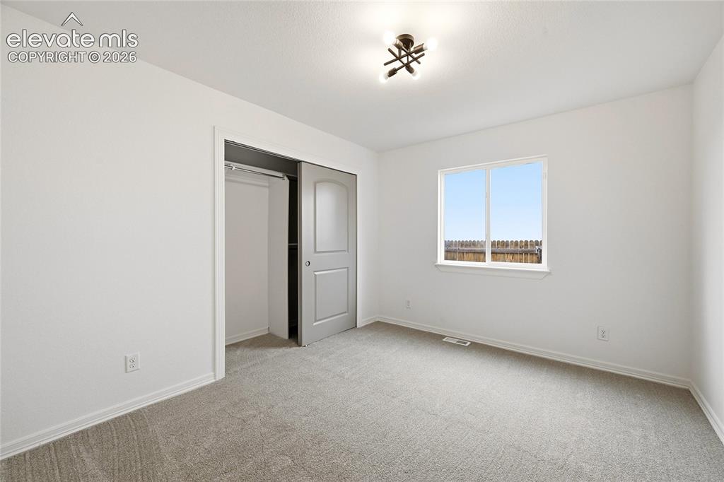 Image 17 of 30: Bedroom featuring neutral carpeting and white painted walls