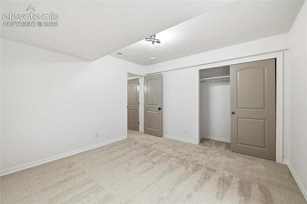 Image 21 of 30: Neutral tone wall paint with light-toned carpeting