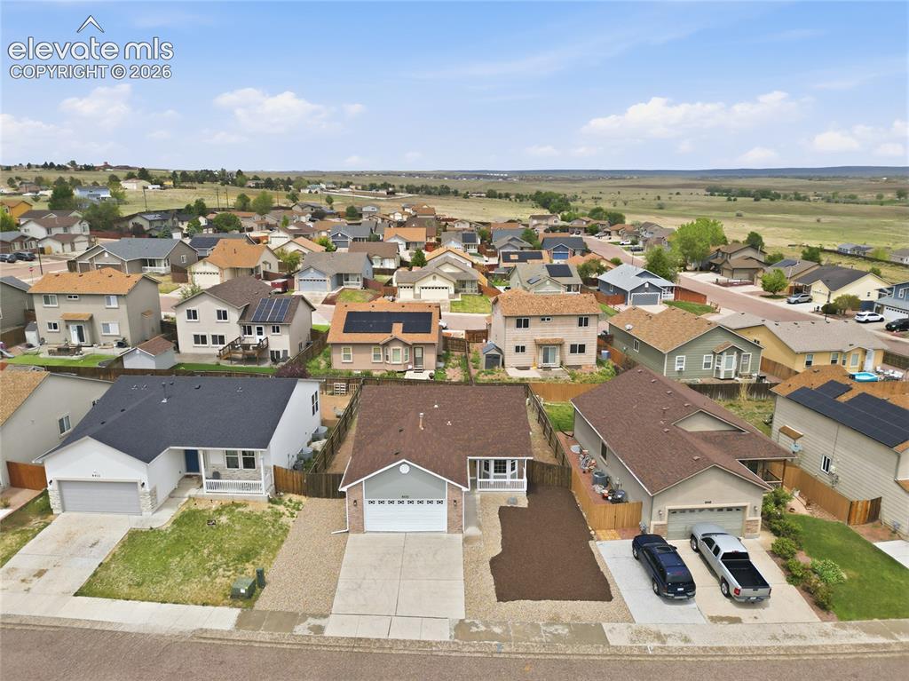Image 27 of 30: Residential street featuring single-family homes with pitched roofs and var