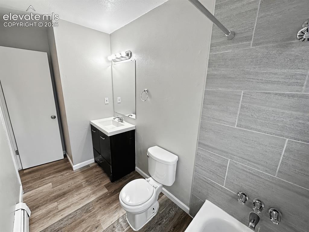 Image 12 of 23: Bathroom featuring a dark wood-finish vanity with a white countertop and in