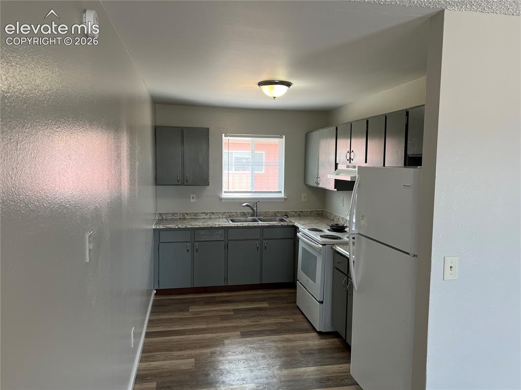 Image 18 of 23: Kitchen featuring wood-finish flooring, grey cabinetry, a stainless steel s