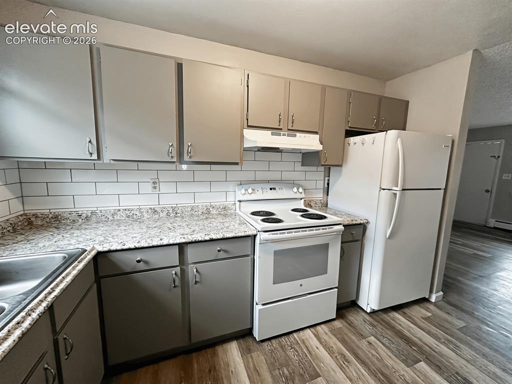 Image 2 of 23: Kitchen featuring gray cabinetry with brushed nickel hardware, white subway