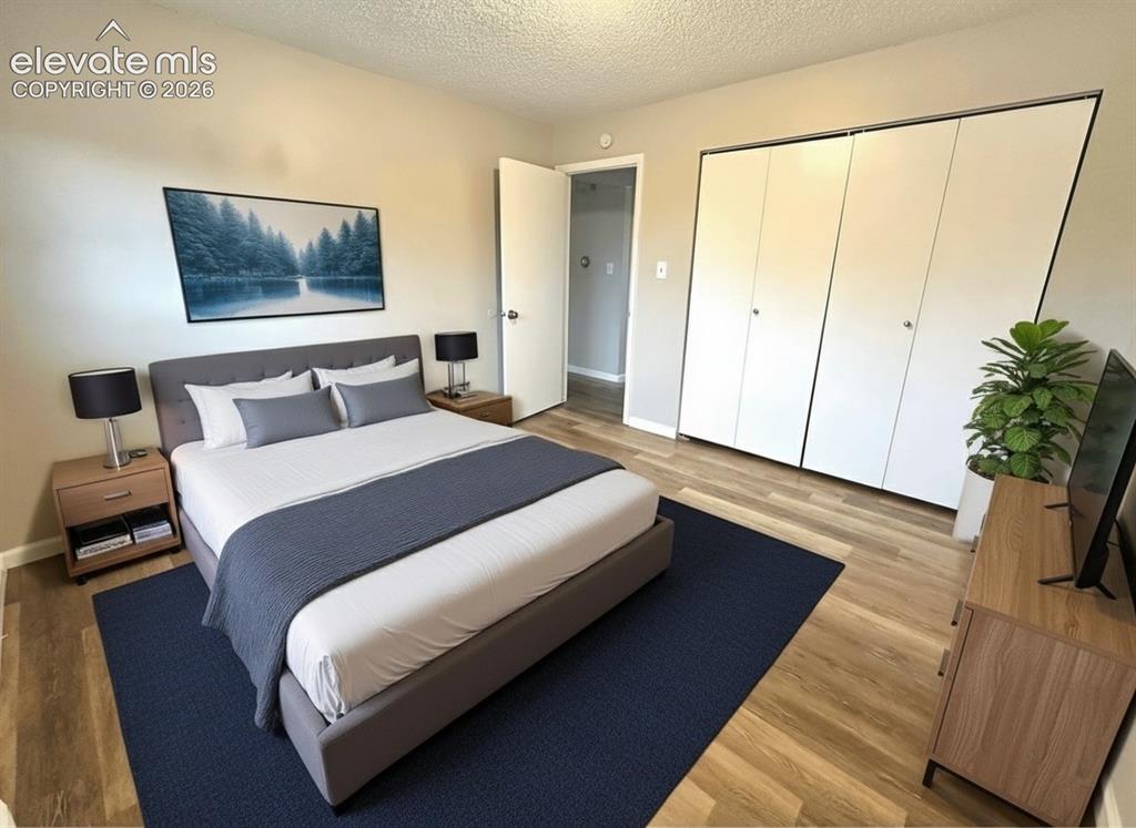 Image 3 of 23: Room featuring wood-finish flooring, light-toned wall paint, and a built-in
