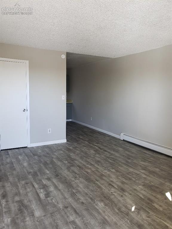 Image 6 of 23: Spacious interior featuring wood-finish flooring, light grey painted walls,