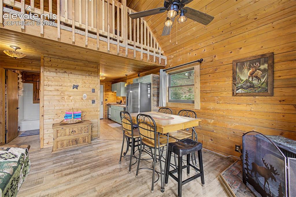 Image 22 of 50: Dining space and vaulted ceilings