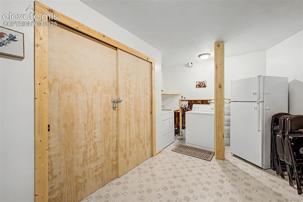 Image 43 of 50: Basement laundry and extra storage space