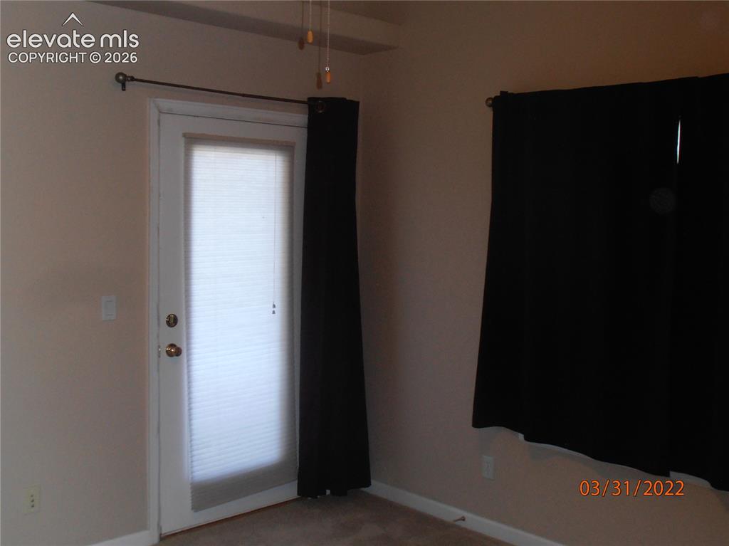 Image 3 of 11: door to deck and 5 piece bath