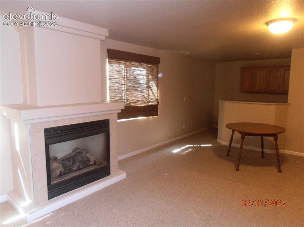 Image 6 of 11: fireplace and wet bar