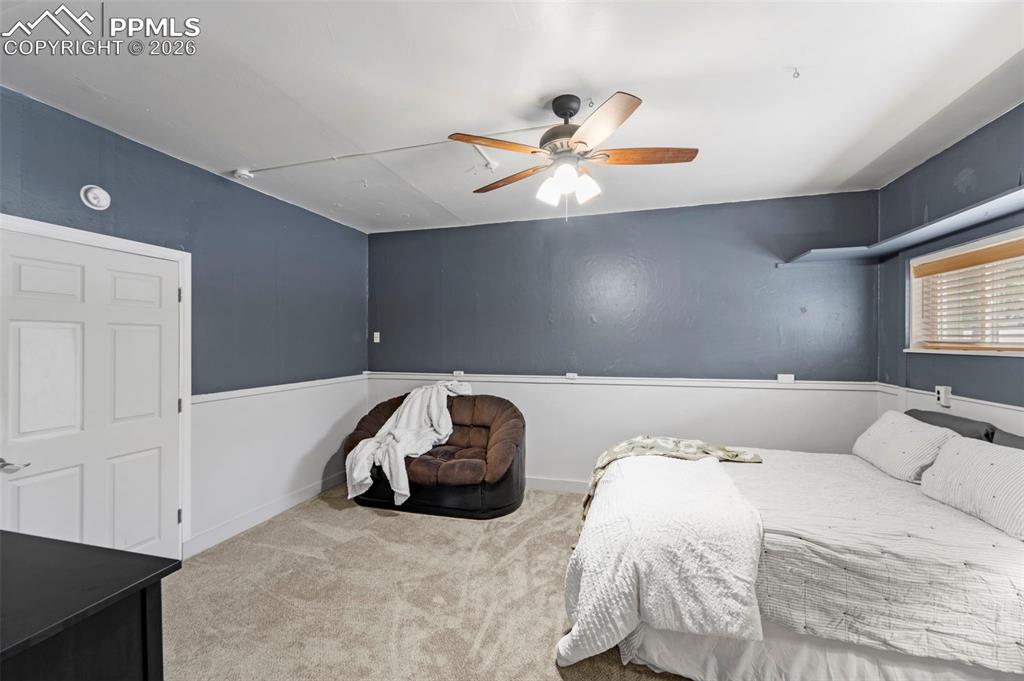 Image 22 of 41: Carpeted bedroom with a ceiling fan and baseboards