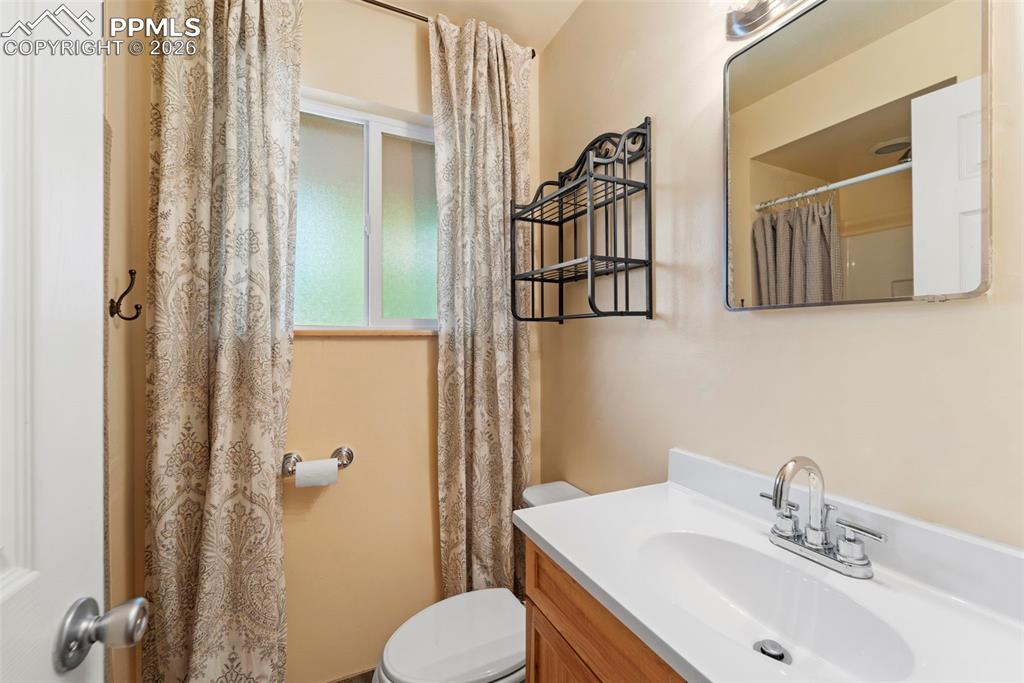 Image 24 of 41: Bathroom with vanity and a shower with shower curtain
