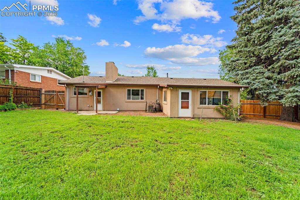 Image 32 of 41: Back of house with a patio area, a fenced backyard, stucco siding, and a ga