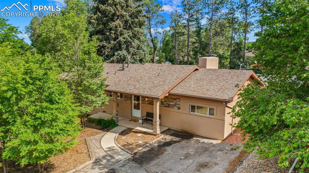 Image 40 of 41: View of front facade featuring a patio area, stucco siding, a shingled roof