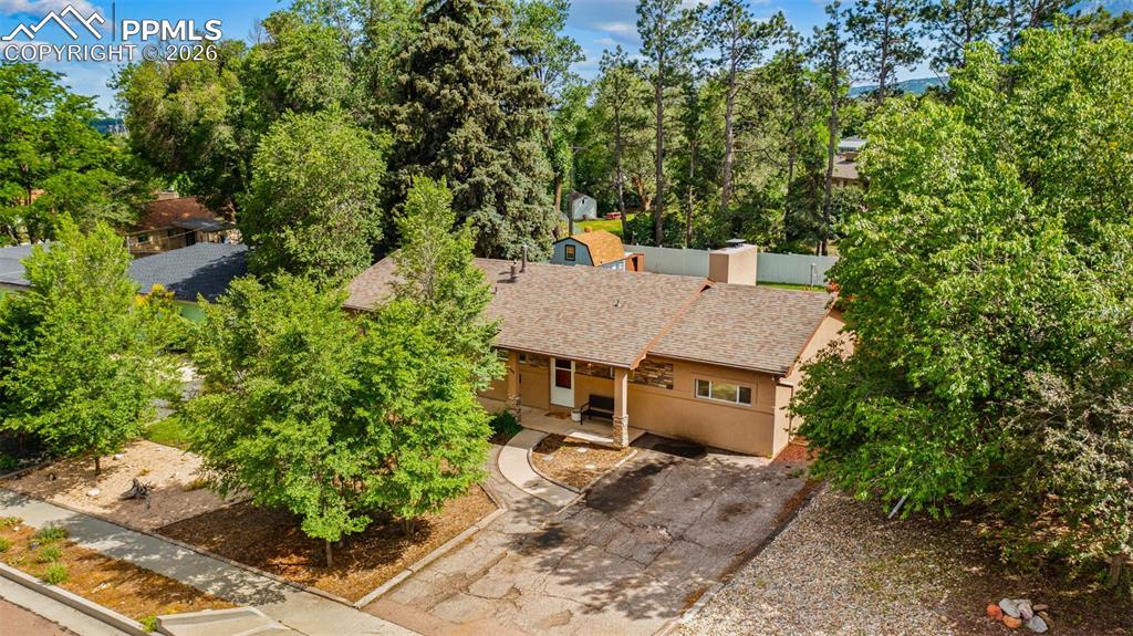 Image 5 of 41: View of subject property featuring a tree filled landscape