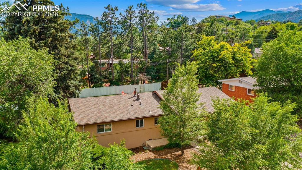 Image 6 of 41: View from above of property with a mountainous background