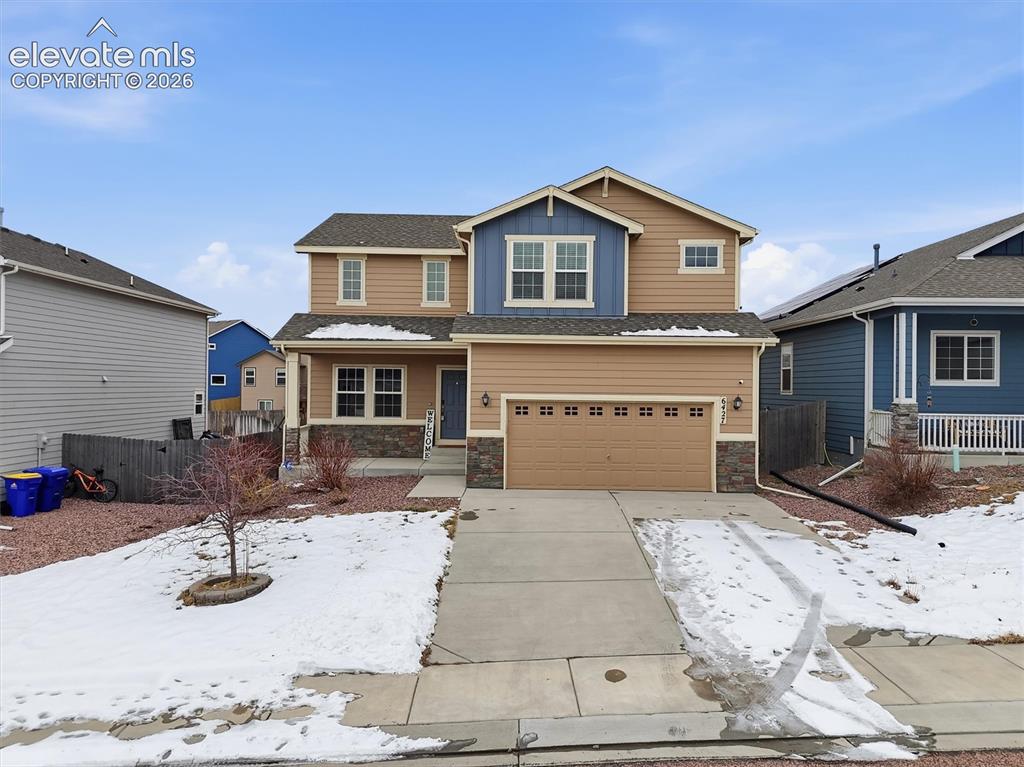 Image 1 of 45: Two-story exterior featuring tan siding, blue gables, a two-car garage, sto
