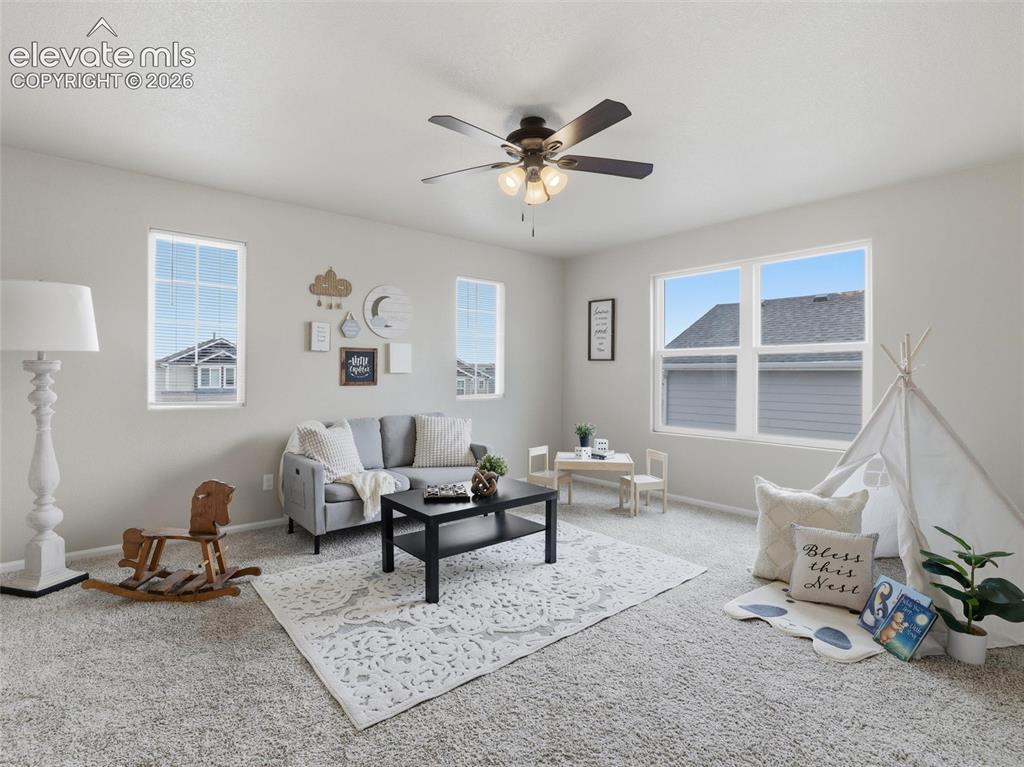 Image 18 of 45: Spacious room featuring light gray walls, plush carpet flooring, multiple w