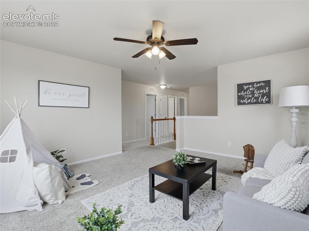 Image 20 of 45: Carpeted room featuring a ceiling fan with integrated lighting, a partial w