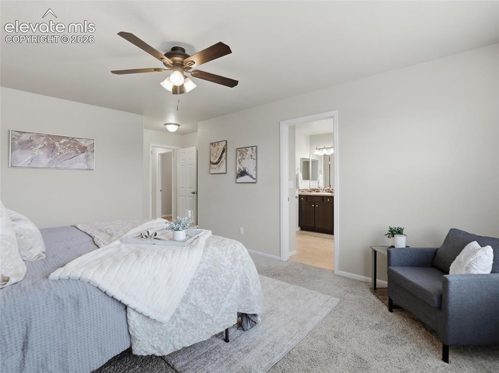 Image 23 of 45: Carpeted bedroom featuring a ceiling fan with integrated lighting, neutral