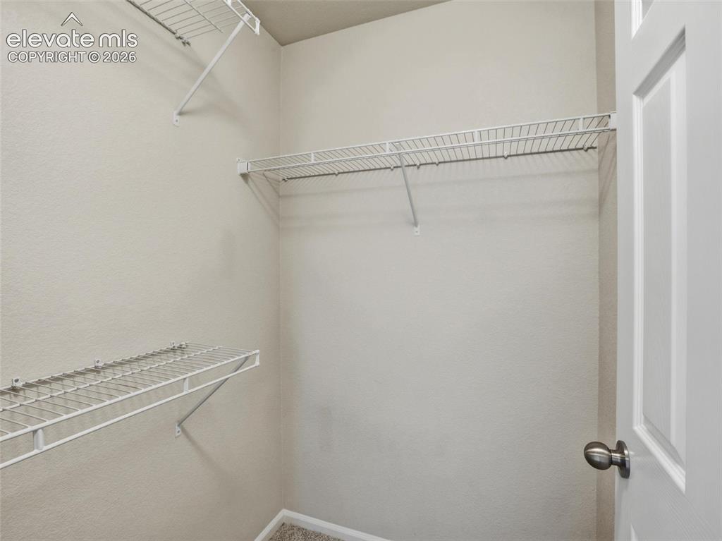 Image 36 of 45: Interior closet featuring wire shelving, neutral wall paint, and carpeting