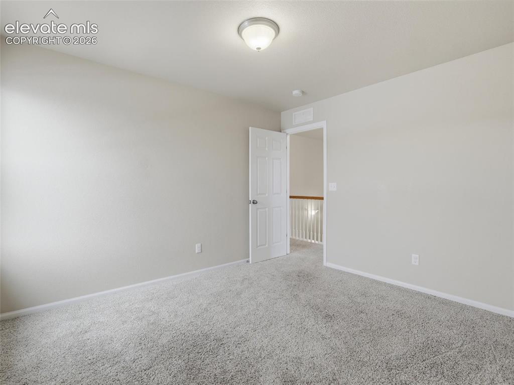 Image 37 of 45: Room featuring light gray walls, textured carpet flooring, a white interior