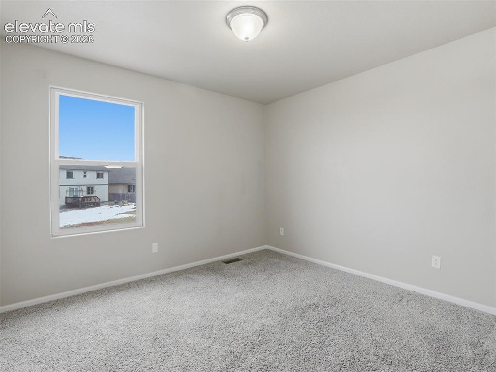 Image 39 of 45: Spacious room featuring neutral paint, gray carpeting, white trim, a single