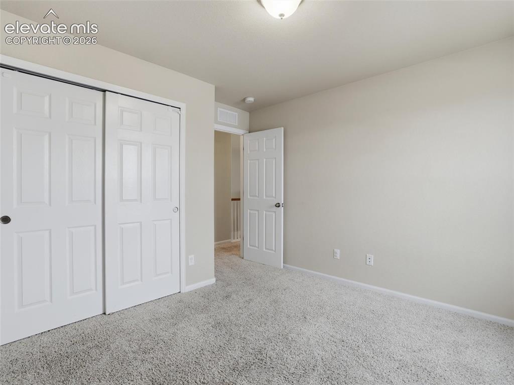 Image 40 of 45: Room featuring light gray carpet, neutral wall paint, and a white ceiling w