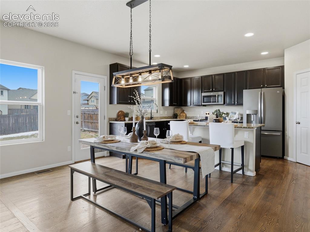 Image 9 of 45: Open-concept living area with wood-finish flooring