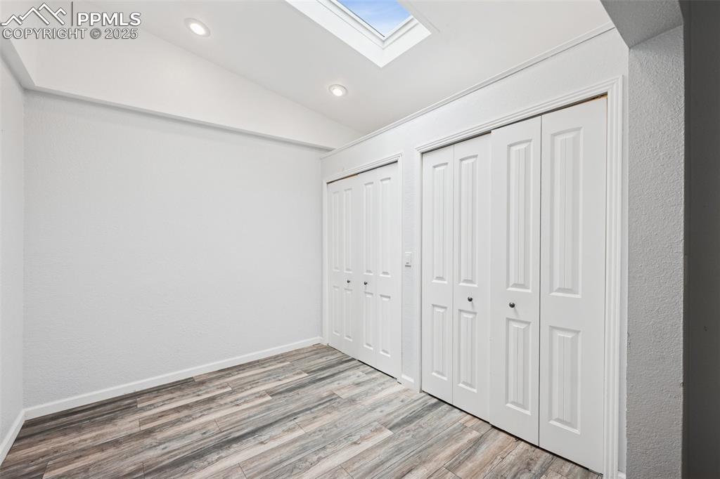 Image 12 of 31: Dressing area in primary bedroom with 2 storage closets with French doors,