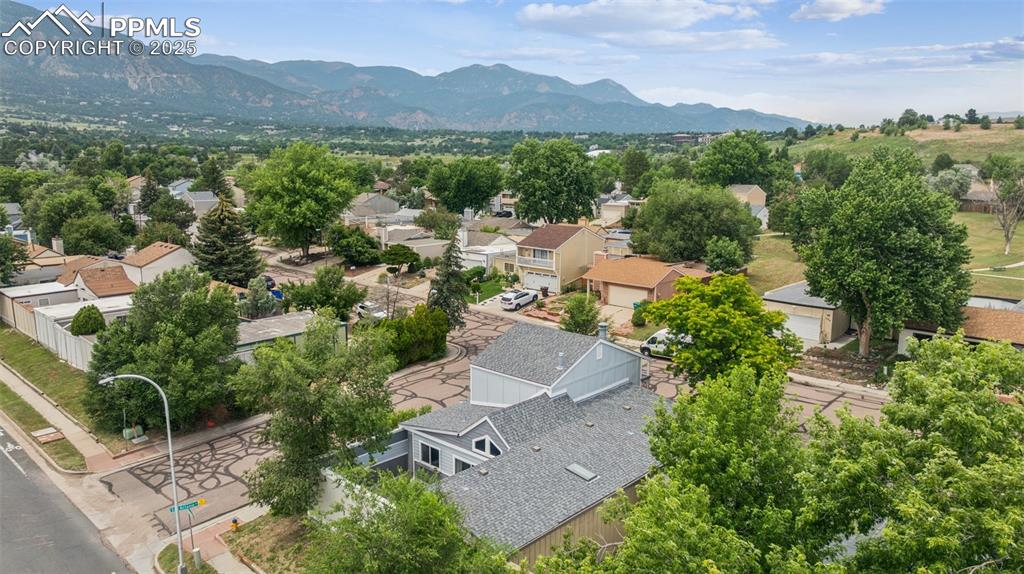 Image 23 of 31: Aerial perspective of surrounding area featuring a mountain backdrop