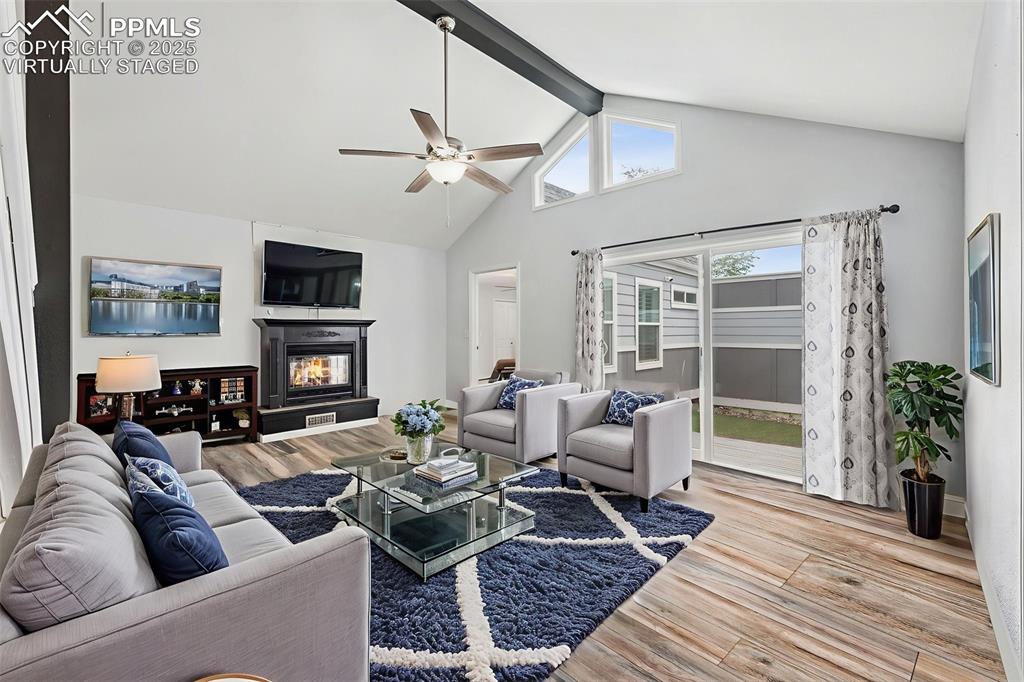 Image 5 of 31: Virtually staged living room featuring ceiling fan, fireplace, stairs, lami