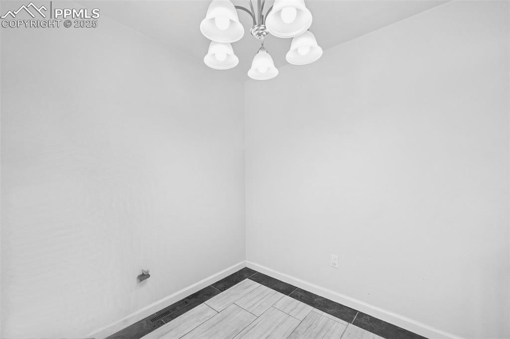 Image 8 of 31: Dining area with chandelier