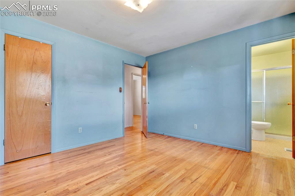 Image 16 of 36: Hardwood flooring throughout, with a light blue wall finish